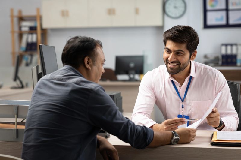 Customer with bank manager in office