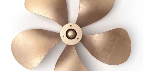 A bronze-colored four-blade propeller against a white background.