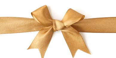 Golden ribbon tied in a bow on a white background.
