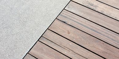 Concrete meets wooden decking at a curved edge.