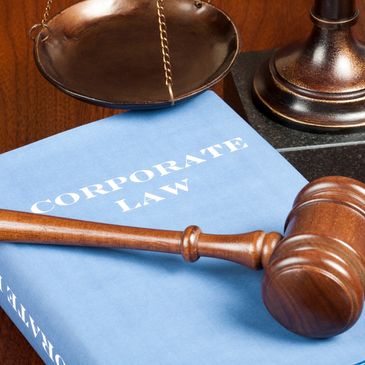 Gavel and scales on a corporate law book.