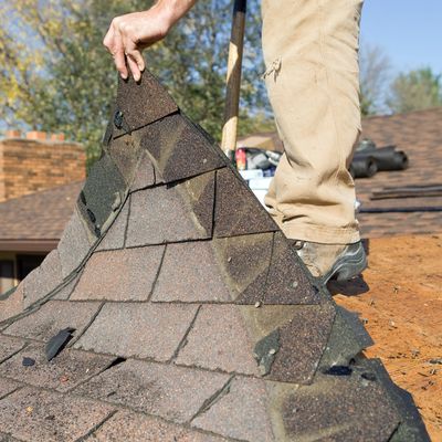 Damaged roof shingles being removed. 