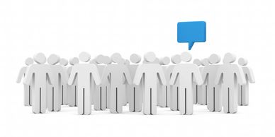 Group of white figures with one having a blue speech bubble.