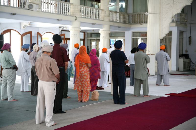 "People praying in a Sikh temple in Ahmedabad, India"