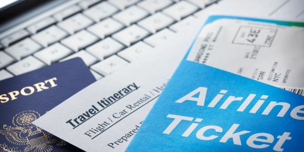 Travel documents including passport and airline ticket.