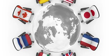 Office chairs with country flags arranged around a globe model.