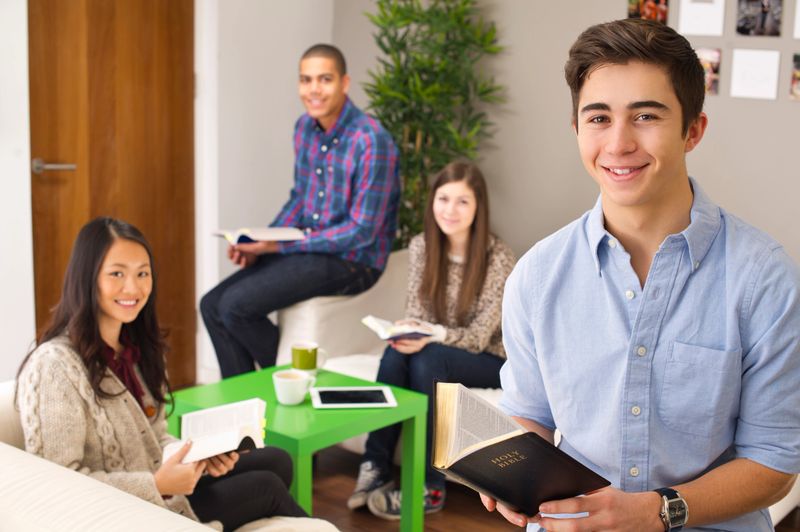 four teenagers at a bible study group