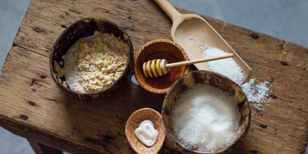 Natural ingredients in wooden bowls on a rustic table.