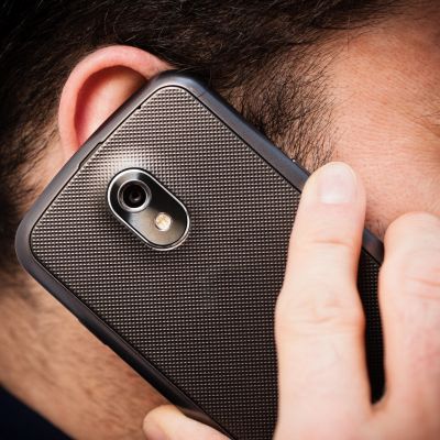 Person holding a smartphone to their ear.