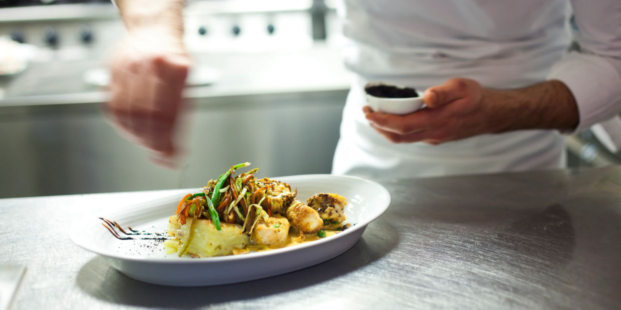 Chef preparing a gourmet dish.