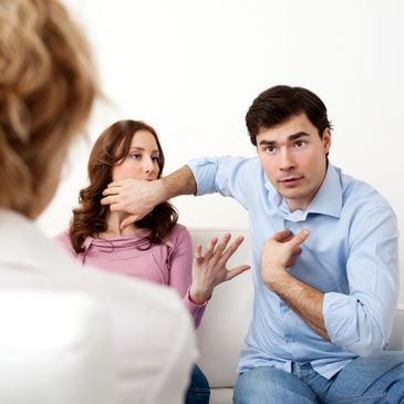 Couple arguing intensely during a therapy session.