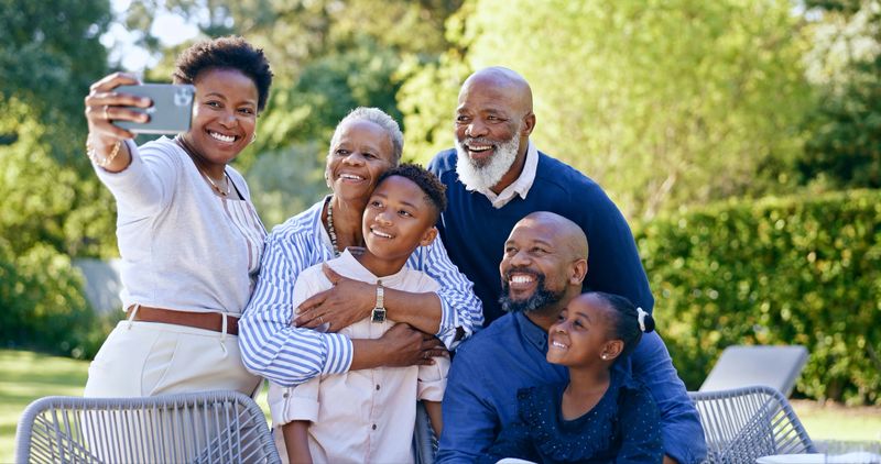 Happy family, selfie or generations in nature, summer vacation or memory together with love. Black people, grandparents, parents or kids smile on face, garden chairs or smartphone to post online