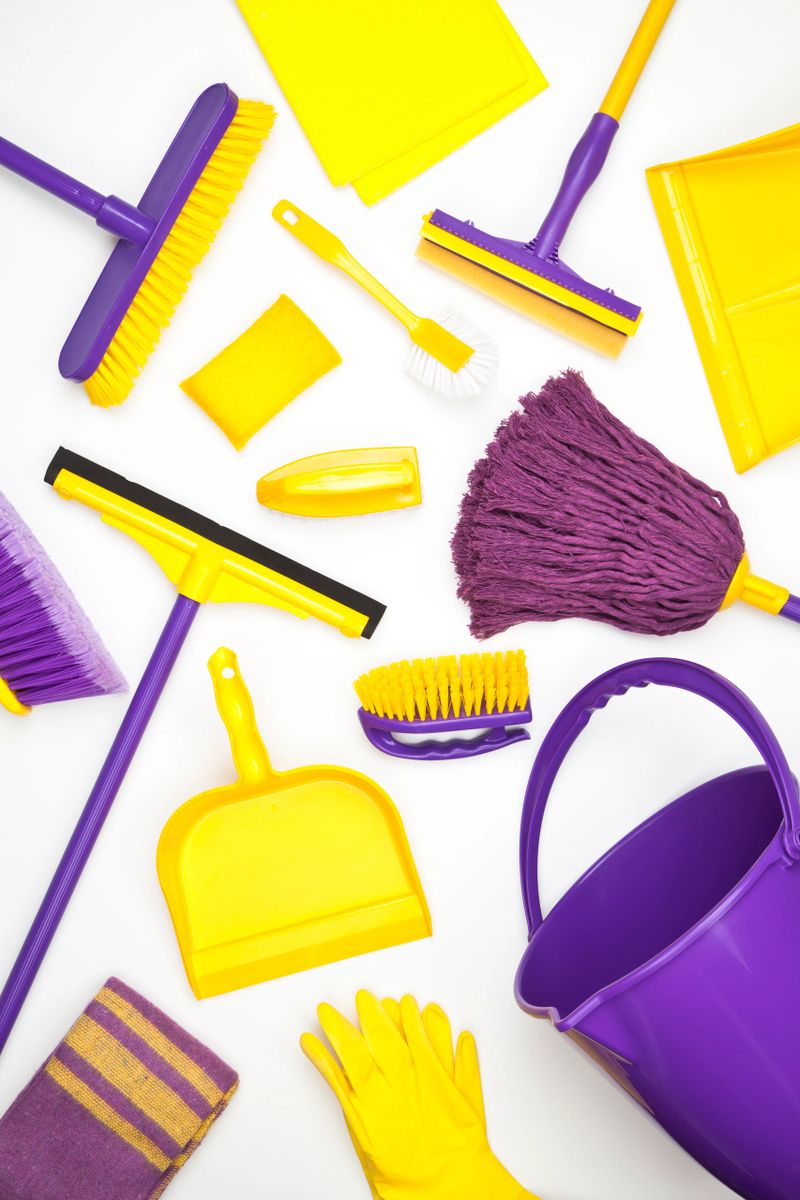 Household Cleaning Supplies Shoot from Above on White Background. Cleaning Concepts.