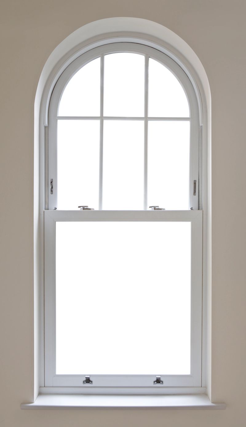 "a beautifully made arched sash window from a luxury house, finished in white. Modern chrome window locks have been fitted whilst the  window frame is set in a caramel coloured wall. Two paths have been included: A Clipping path for the window panes (to enable you to place a background image of your choice) and a path around the arch and sill, to enable a change of wall colour.Looking for a window Please see my window collection including cut-outs with clipping paths by clicking on the Lightbox Link below..."
