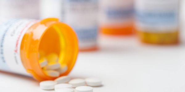 Close-up of white tablets used for oral weight loss medication treatment.