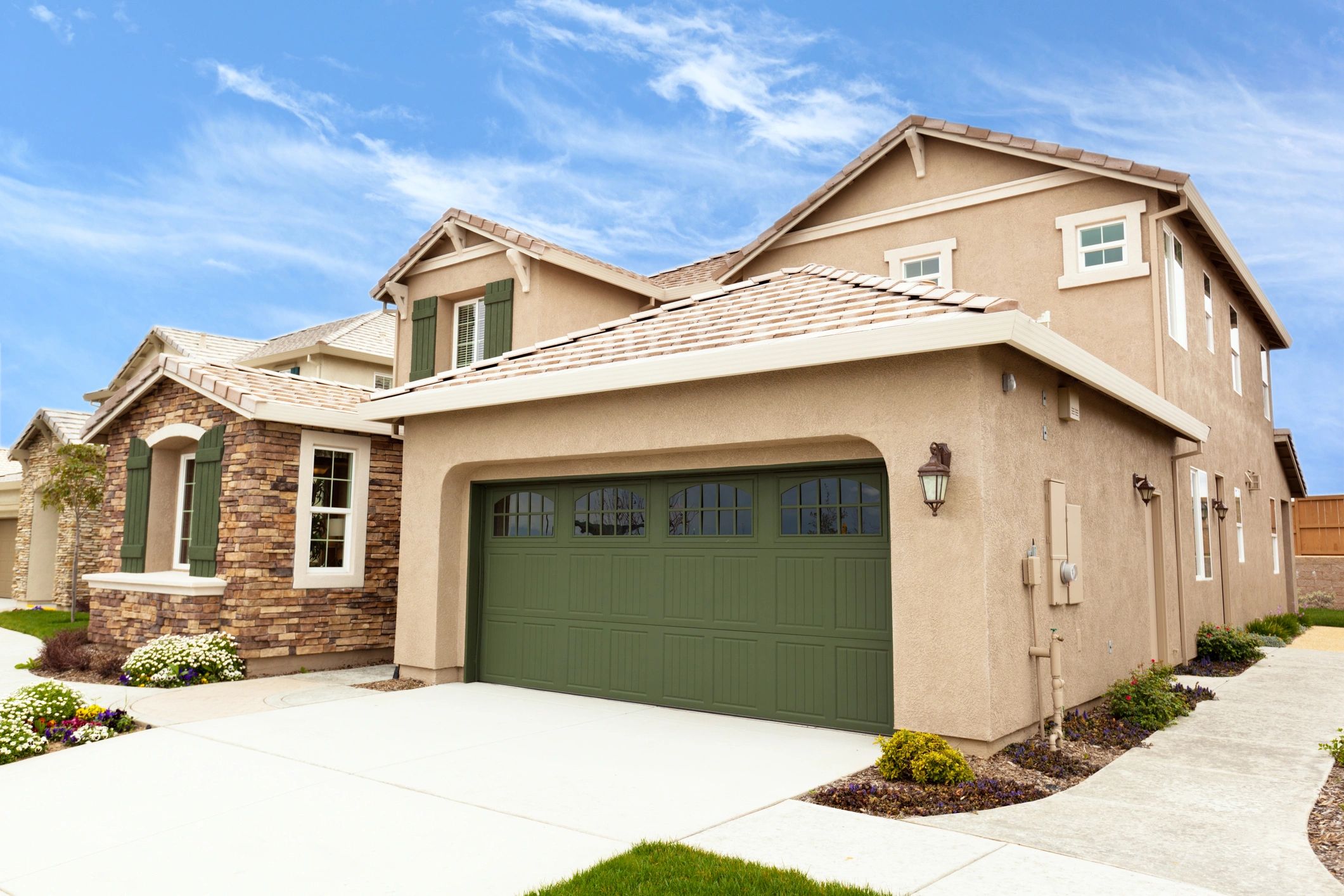 concrete home with spacious garage door 