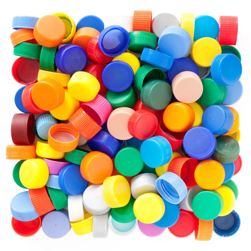 Lots of multicolored plastic bottle caps shaping a square