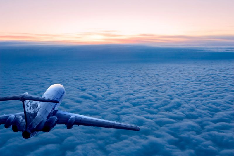 Passenger airplane on the clouds background. Flight in stratosphere. Daybreak.