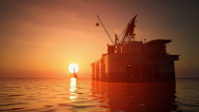 Oil rig at sunset, symbolizing energy exploration.