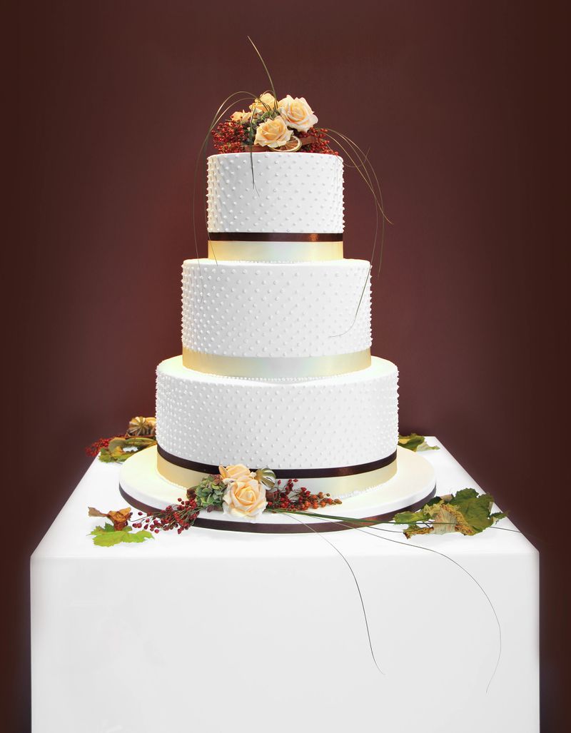 Big white wedding cake decorated with flowers