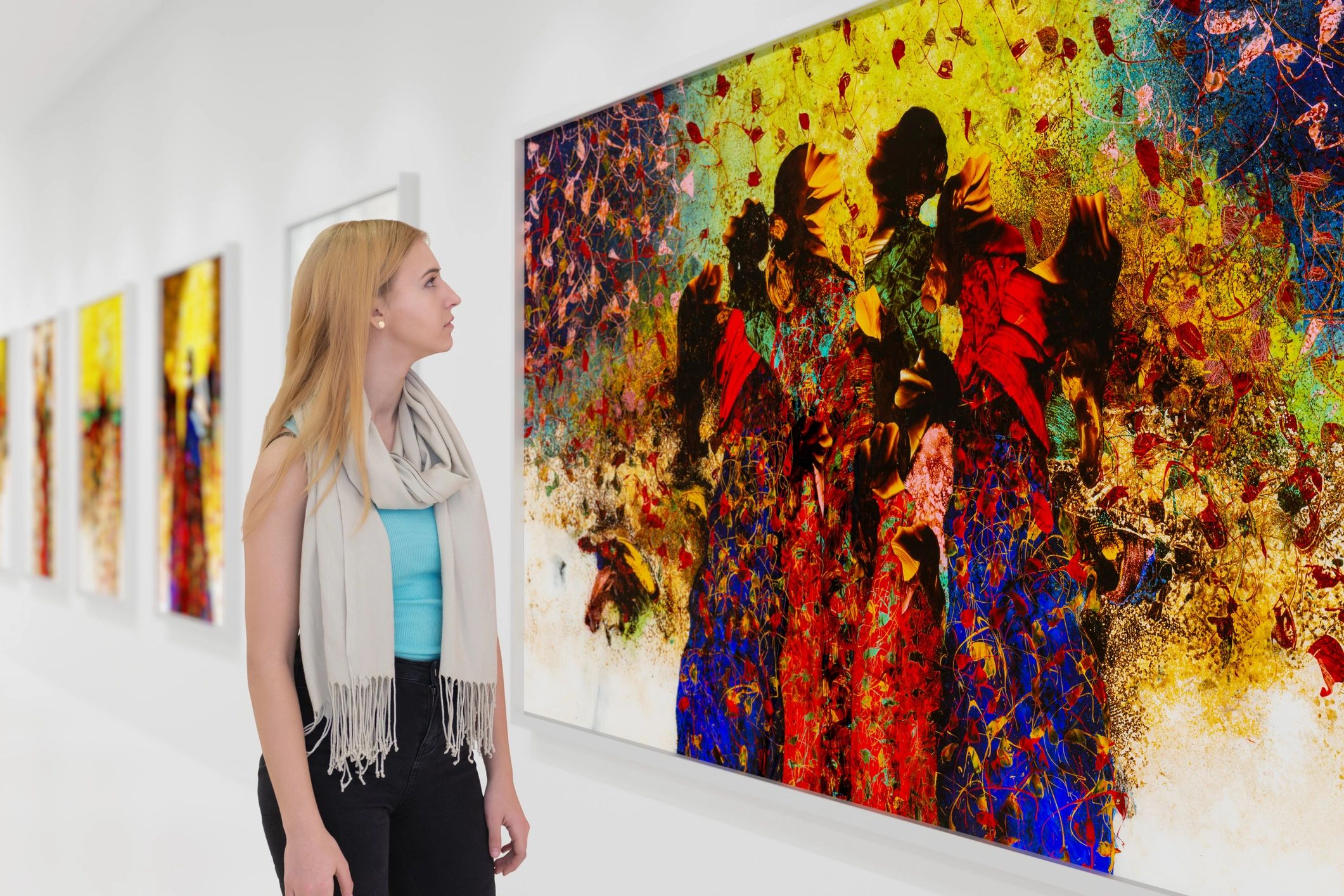 Woman admiring vibrant abstract art in a gallery.