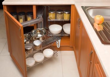 Open kitchen cabinet with organized shelves and dishes.
