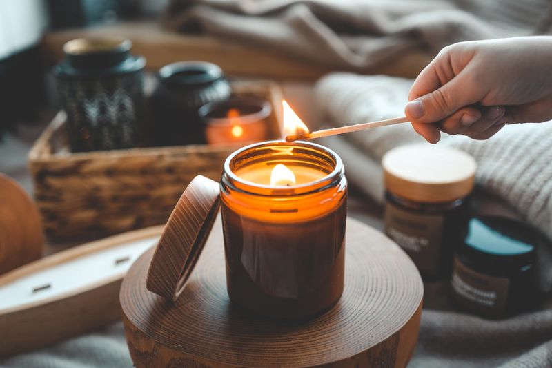 Match in hand lighting candles, aesthetics.