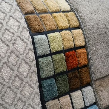Display of carpet samples in various colors and patterns.