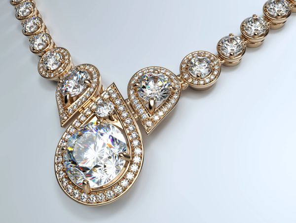 Elegant gold necklace with sparkling diamond accents and teardrop-shaped centerpiece.