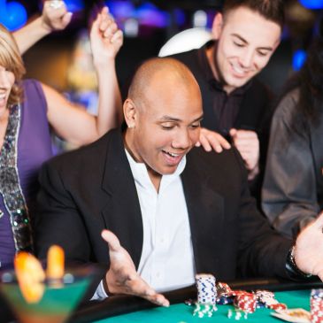 Man excitedly celebrating poker win at casino.