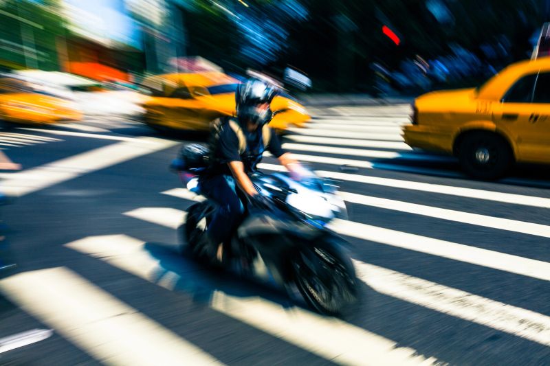 Fast motorbike and taxi in New York, blurred motion
