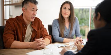 Couple discussing with a consultant.