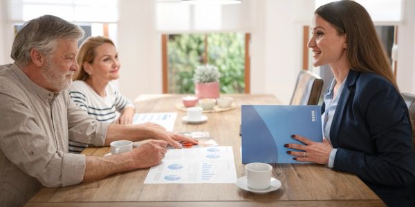 Couple discussing financial documents with advisor.