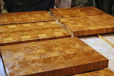 Multiple wooden cutting boards with a checkered end-grain pattern.