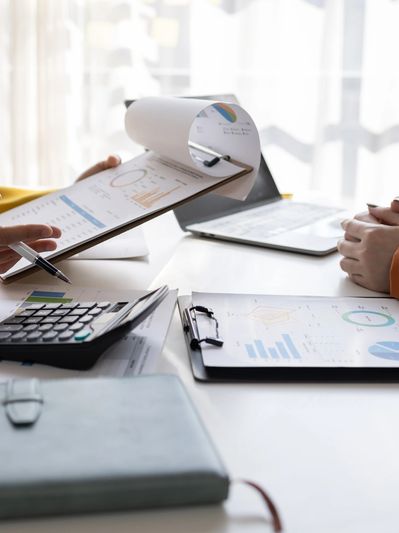 People reviewing financial charts and data at a desk.