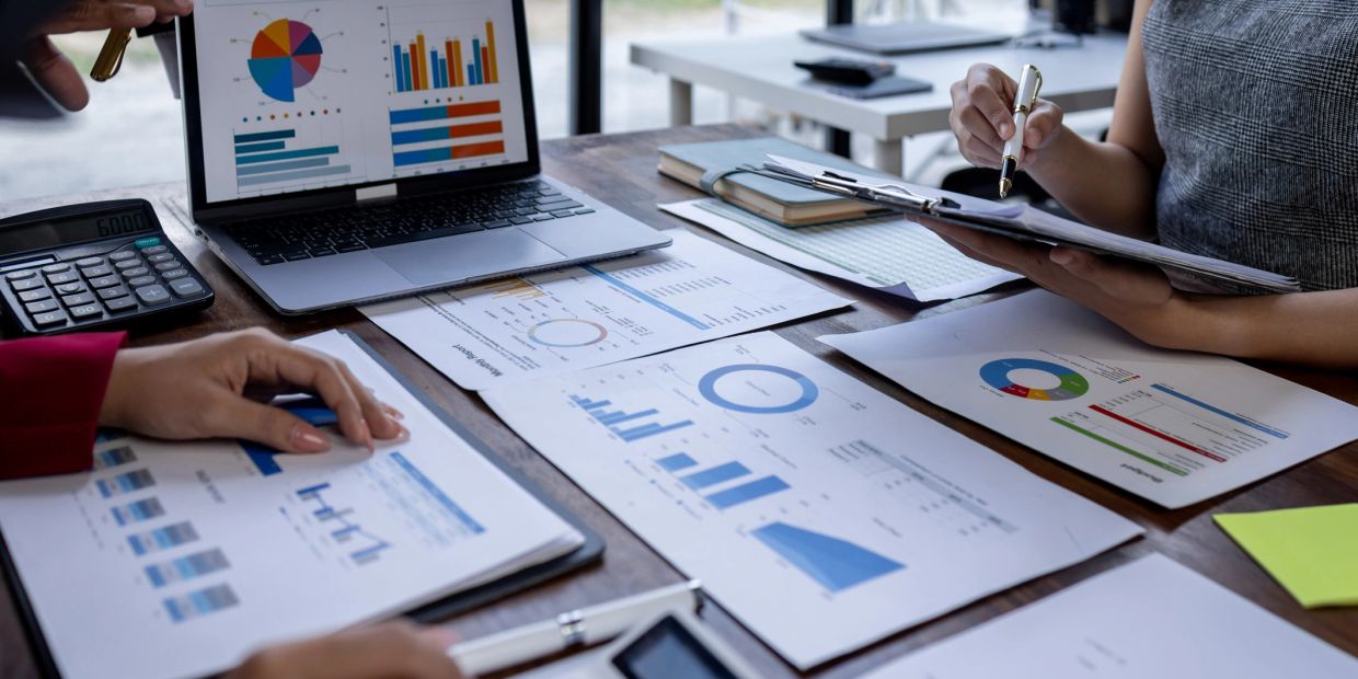 People analyzing charts and graphs during a business meeting.