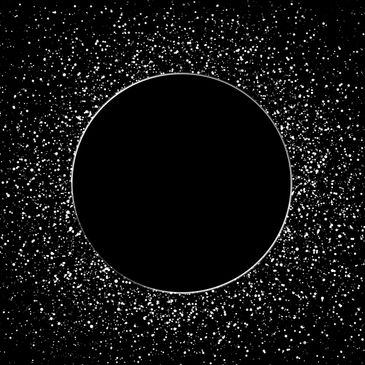 Black circle surrounded by white speckles resembling stars in space.