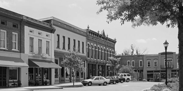 Historic downtown street with vintage buildings and parked cars.