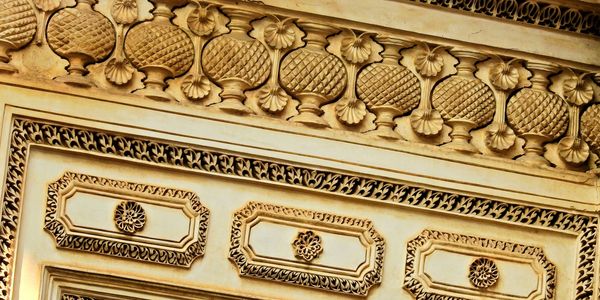 Ornate golden architectural details with intricate patterns and floral designs.