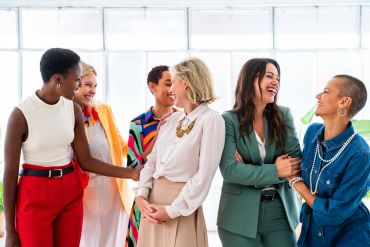 Group of diverse women laughing and enjoying each other's company.