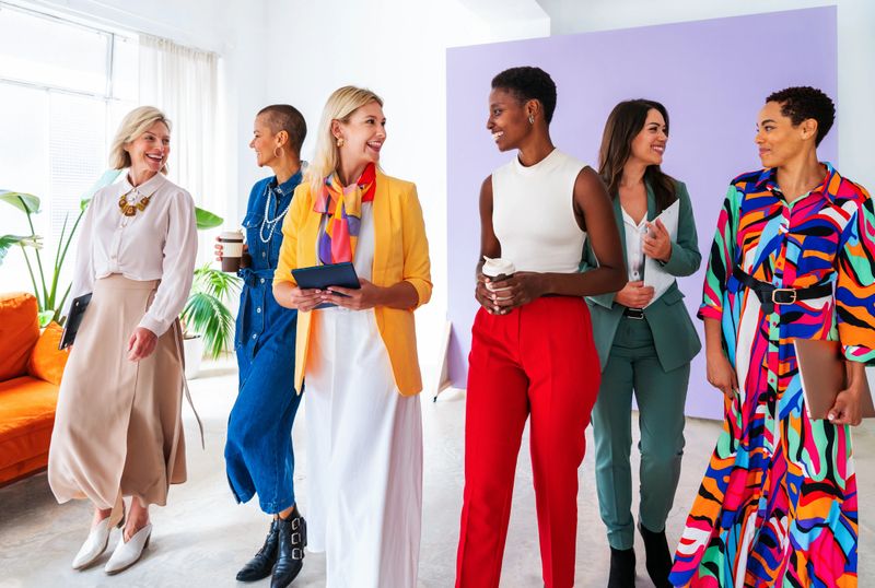 Group of beautiful confident businesswomen meeting in the office - Multiethinc female creative team brainstorming at work - Diverse colleagues working together  in workshop  in a co-working space