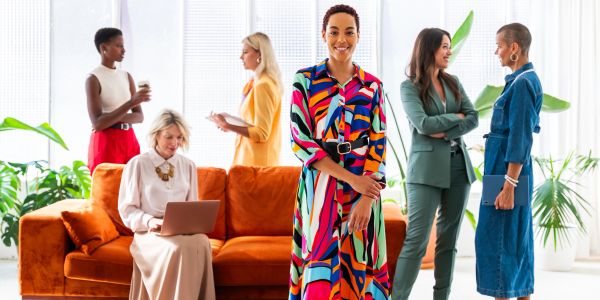 Diverse women interacting in a bright office.
