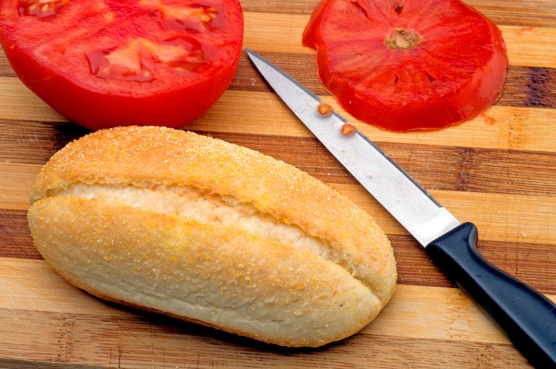 bread and tomato on cutting board