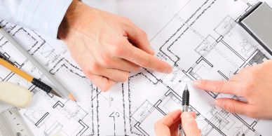 People discussing architectural blueprints.