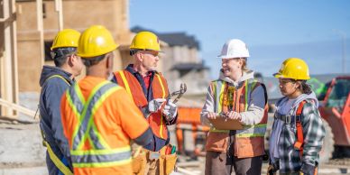 Construction workers discussing on site.