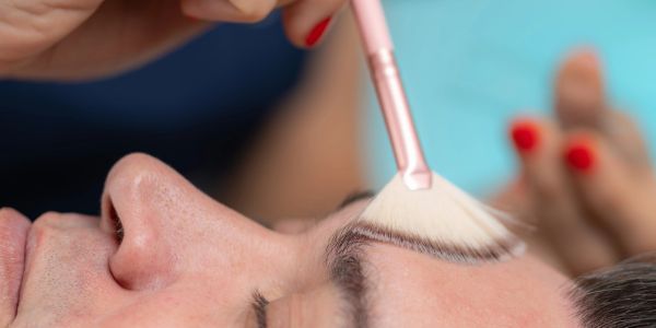 Applying makeup with a brush on eyebrows.