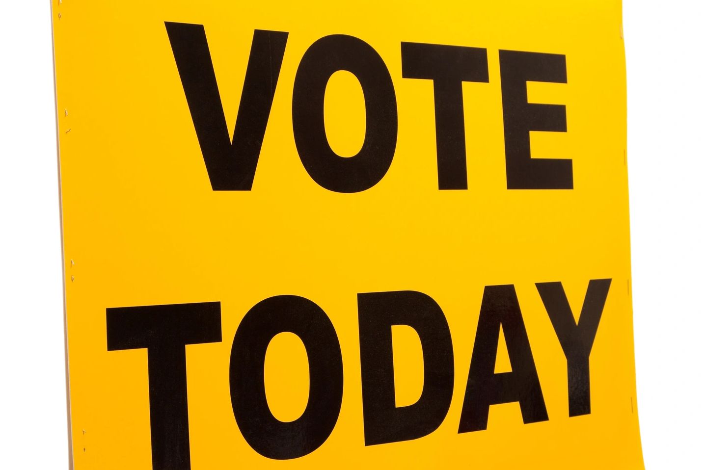 Yellow sign with bold black text saying 'VOTE TODAY'.