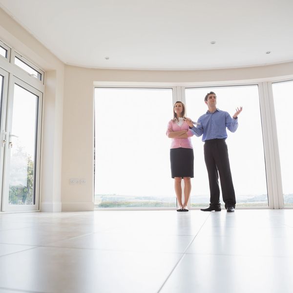 Woman and estate agent in new house
