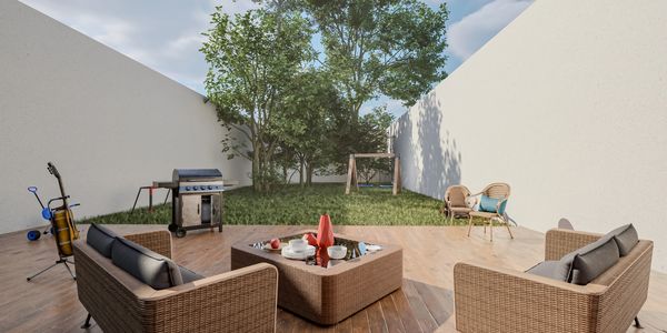 Cozy backyard patio with wicker furniture and green lawn under blue sky.