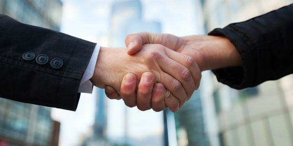 Close-up of a handshake between two people.